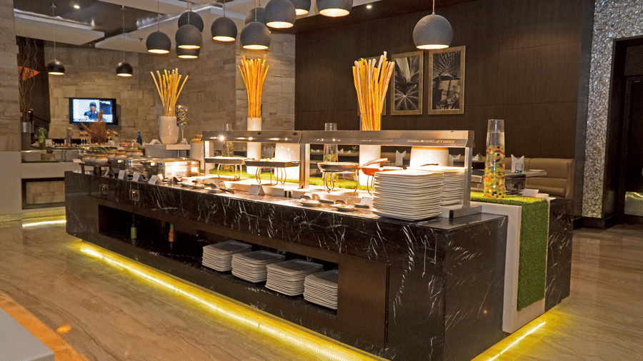 Modern buffet restaurant with live counters and seating at Park Plaza, Ludhiana.
