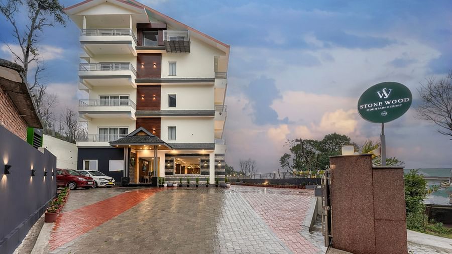 Facade image of Stone Wood Mountain Resort, Dharamshala with dark skies in the background
