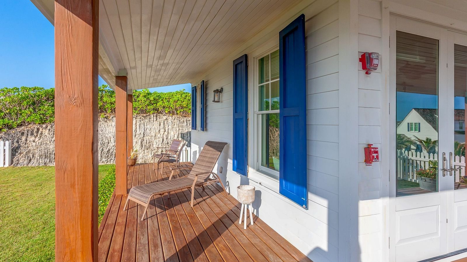 Close-up of Hill Top Cottage at Abaco Inn from the deck area with outdoor seating.