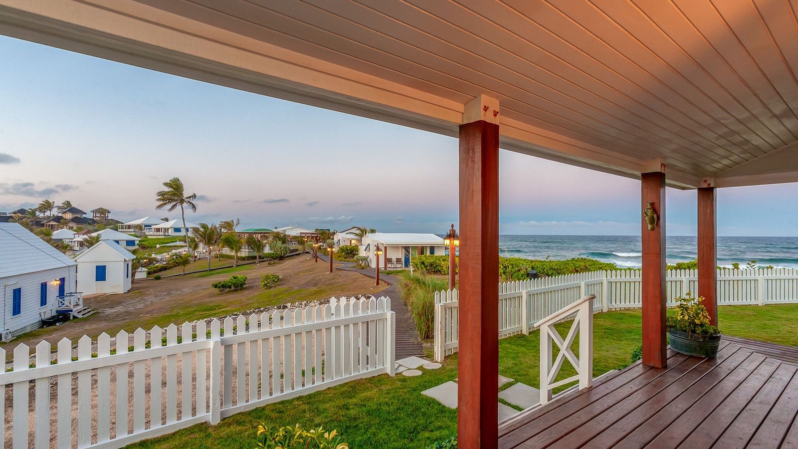 Wrap-around veranda of Hill Top Cottage at Abaco Inn with distant views of the coastline.