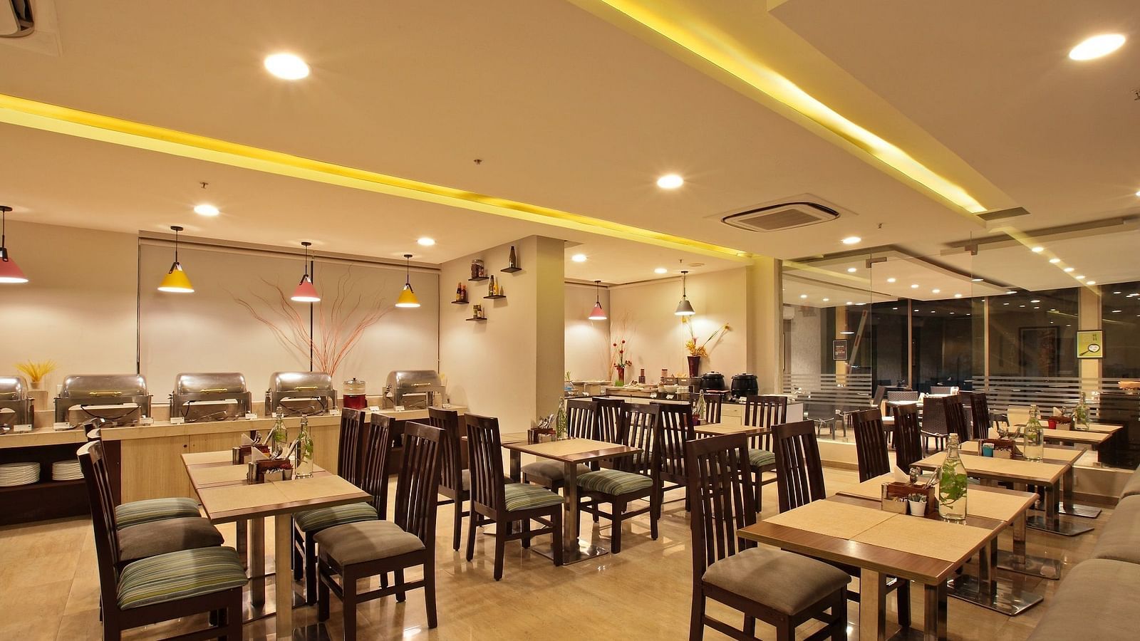 Seating arrangement in the restaurant at Starlit Suites, Bangalore