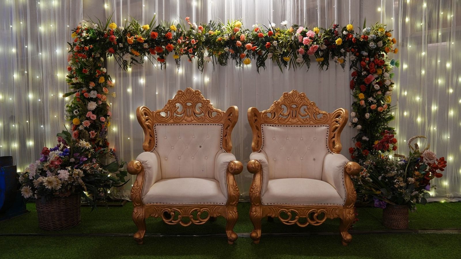 A closeup view the decorated stage with flowers - The zion.