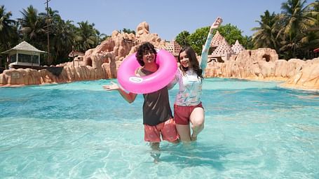 An image of a man and a woman enjoying themselves at the Wetlantic wave pool - Water Kingdom
