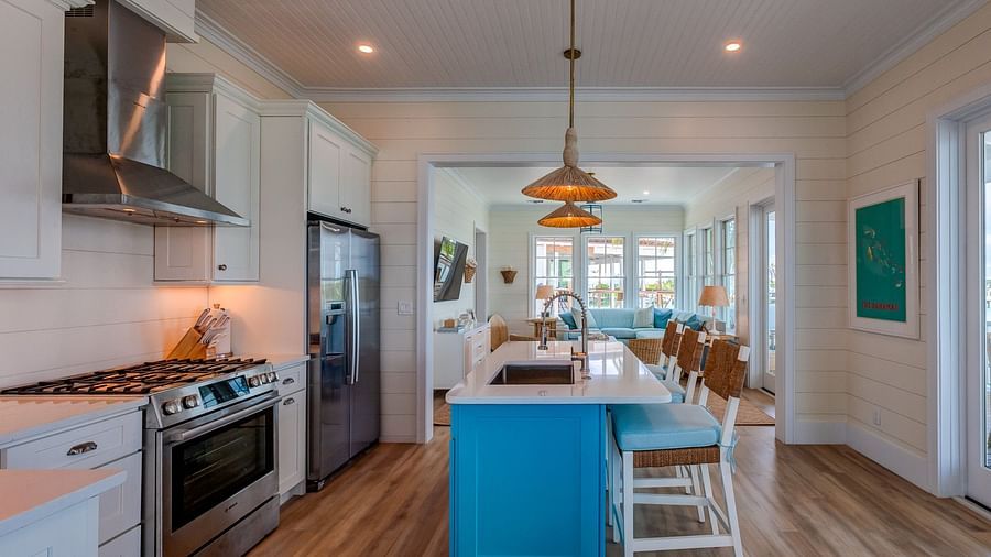 Modern kitchen with blue cabinetry, a large island, and appliances | Abaco Inn
