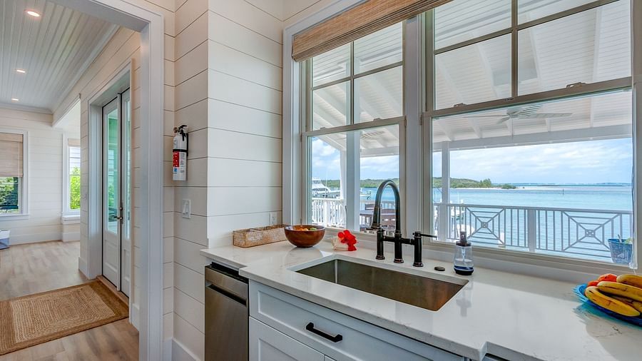 Kitchen with a water view, white cabinetry, and modern appliances | Abaco Inn
