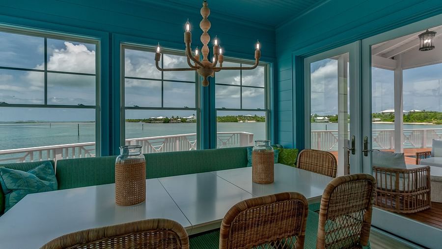 Dining room with a coastal chandelier and floor-to-ceiling windows | Abaco Inn