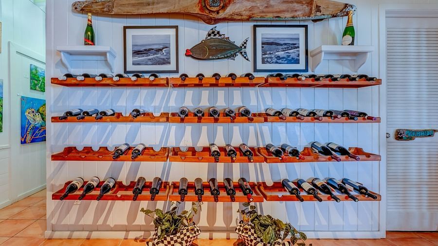 Wall-mounted wine rack with red wine bottles | Abaco Inn