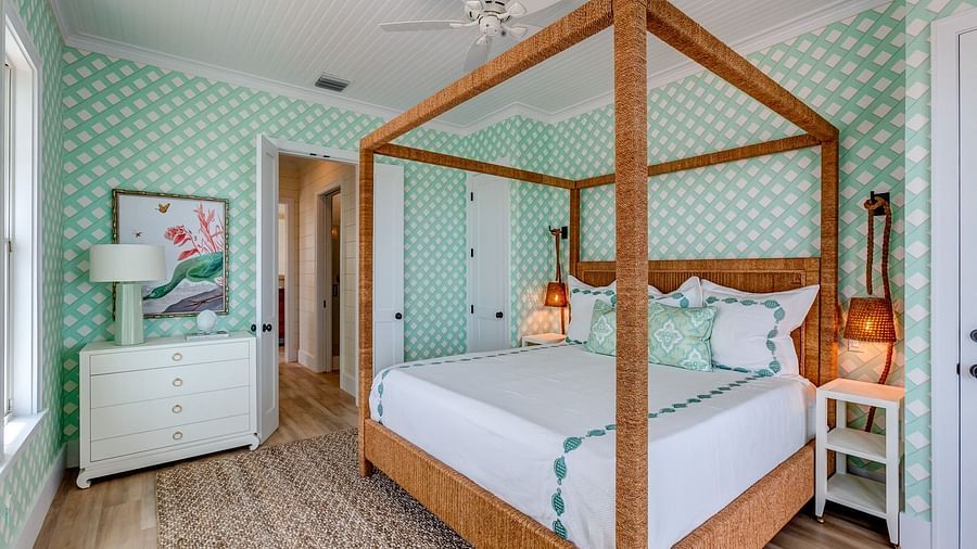 Bedroom with a wooden canopy bed and mint-green walls | Abaco Inn