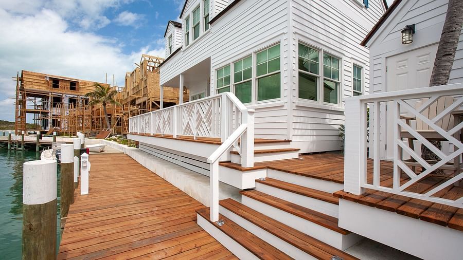 Wooden deck with steps leading to a white coastal-style building | Abaco Inn
