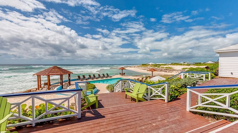 Outdoor wooden deck with tables, chairs, and gazebo nearby | Abaco Inn