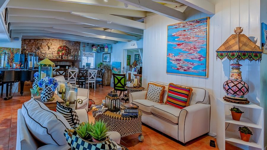 A lounge with sofas, artistic decor, rustic furnishings, and soft lighting | Abaco Inn