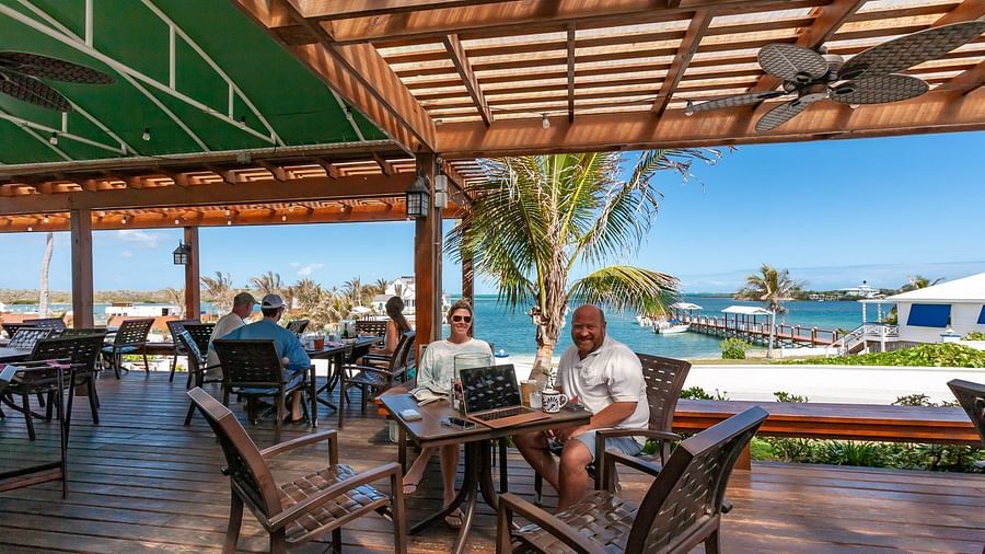 Outdoor dining area with ocean view and wooden roof | Abaco Inn