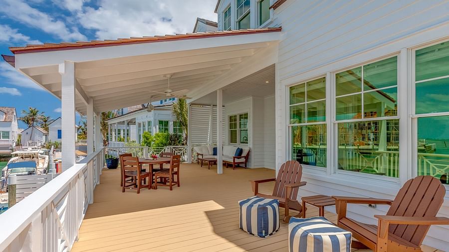 Outdoor seating area on a covered patio with wooden flooring | Abaco Inn
