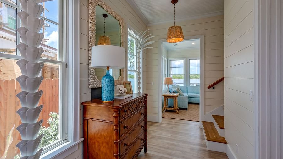 Hallway with coastal decor, wooden furniture, and large windows | Abaco Inn