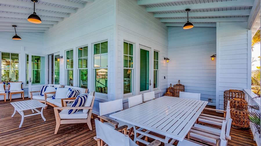 Open-air dining area with a long white table and cushioned seating | Abaco Inn