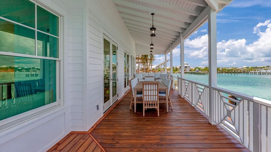 Outdoor dining area on a wooden deck with ocean views | Abaco Inn