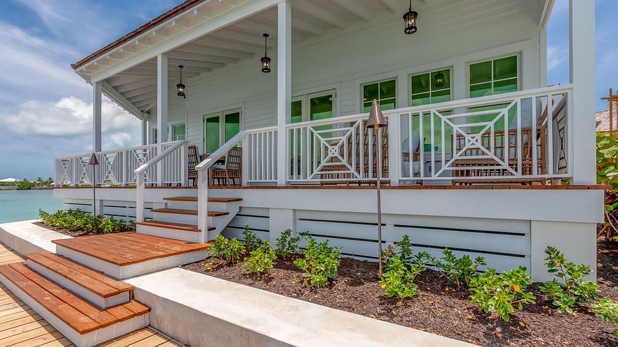 Exterior of a coastal villa with a wraparound porch and garden | Abaco Inn