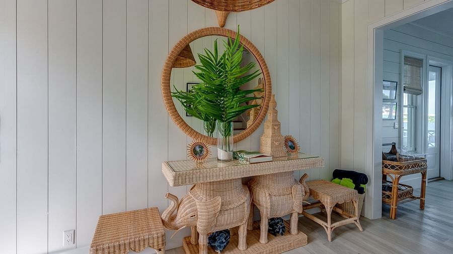 Wooden dining table with bench seating, potted plant, and white walls | Abaco Inn
