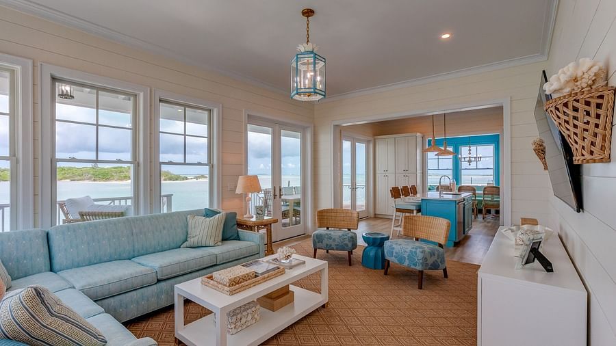 Living area with pastel blue seating, large windows, and décor | Abaco Inn