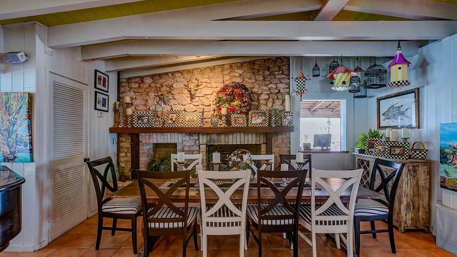 Dining area with tables, chairs, and stone accent wall | Abaco Inn