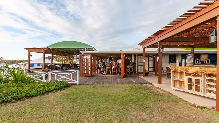 Restaurant with wooden roof and garden by the beach | Abaco Inn