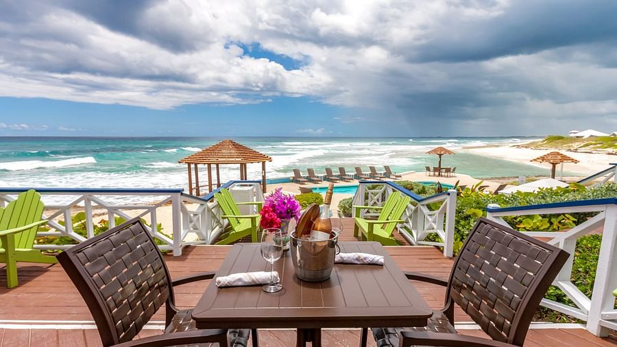Table with drinks and flowers facing the ocean | Abaco Inn