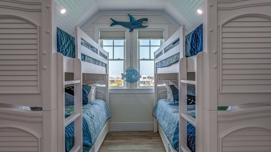 a room with two bunk beds and windows with a sea view at Abaco Inn.