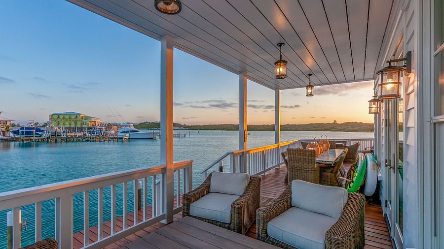 Sitting area on the dock with comfortable chairs and a table with the sea view at Abaco Inn.