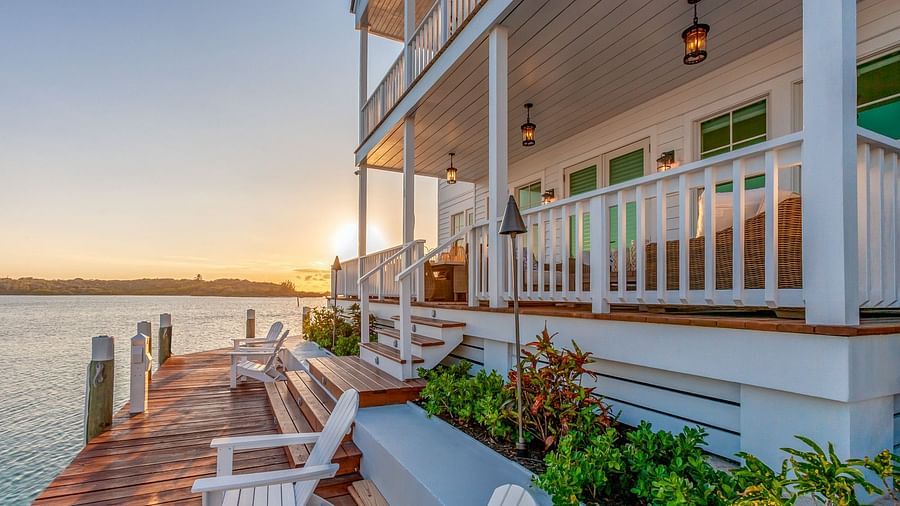 facade of  Abaco Inn with chairs on the dock and a view of the sea.
