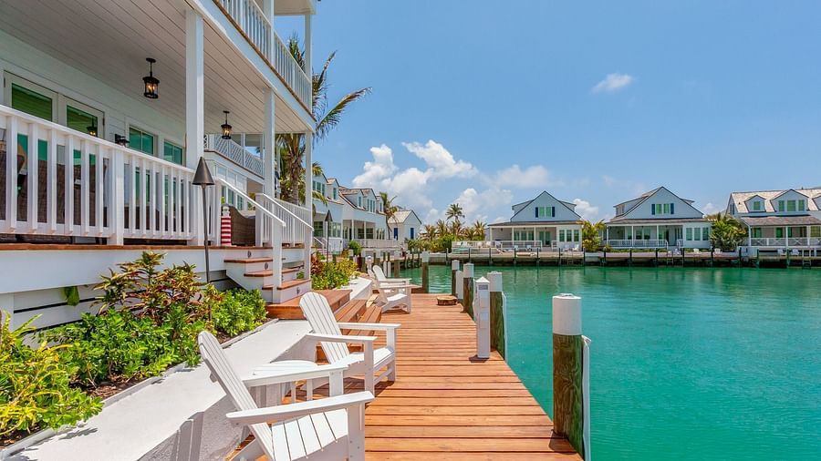 facade of  Abaco Inn with chairs on the dock and a view of the sea.