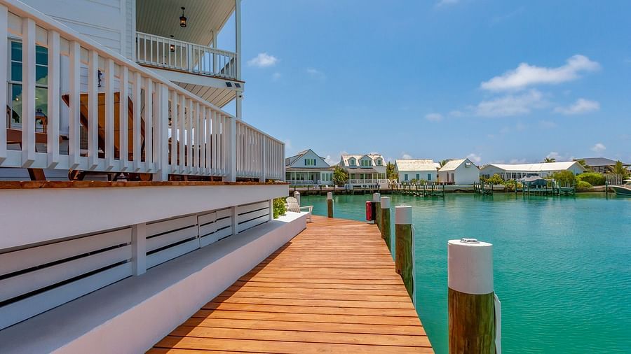 side view of Abaco Inn on a dock with a sea view.