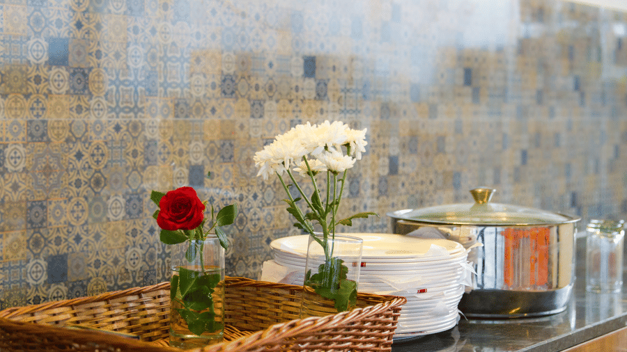 Fresh flowers and serving dishes at the Sanctum Suites breakfast buffet Whitefield.