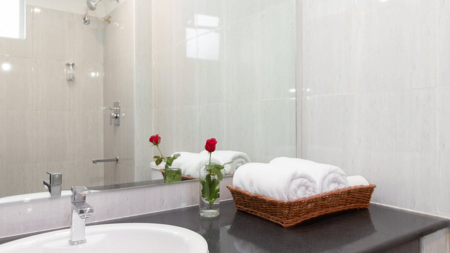 Spacious bathroom with a vanity and a sink at Sanctum Suites Whitefield, Bangalore.