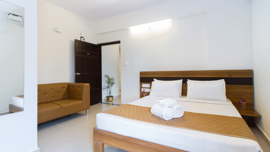 Spacious studio at Sanctum Suites, including a sofa and rooms near Whitefield railway station.