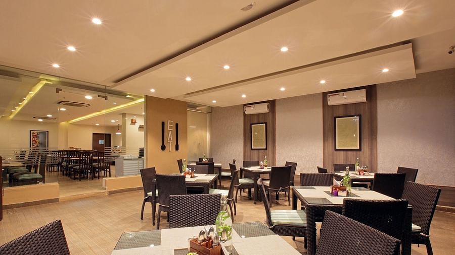 Seating arrangement in the restaurant at Starlit Suites, Bangalore