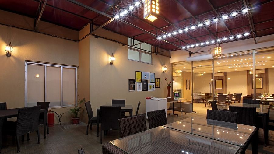Seating arrangement in the restaurant at Starlit Suites, Bangalore