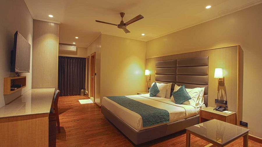 A double bed inside Pool view room - The Cindrella Hotel, Siliguri