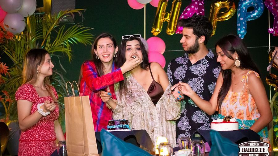 An image of a group of people enjoying in a birthday party at Themis Barbecue HOuse, NSP Pitampura