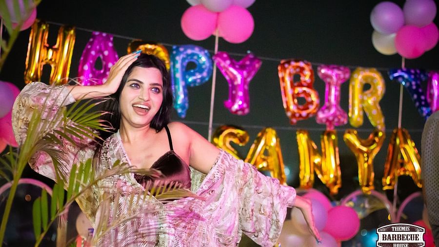 An image of a woman enjoying herself at a birthday party in Themis Barbecue House, NSP Pitampura