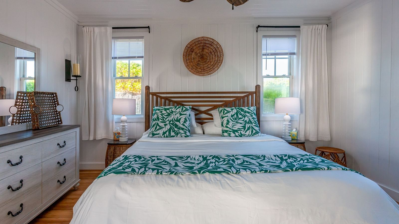 Hill Top Cottage bedroom at Abaco Inn with bed, side tables and bright interiors.