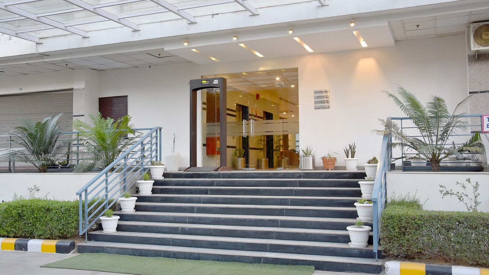 Entrance view of Starlit Suites, Neemrana with potted plants on the steps