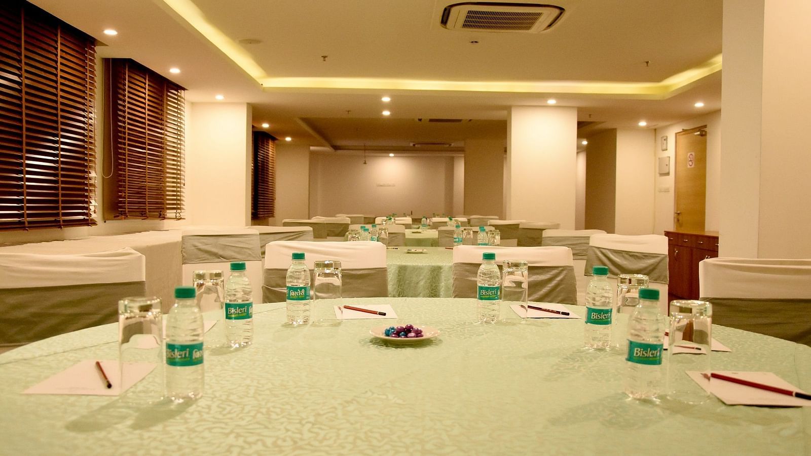 Round table seating arrangement inside the banquet hall - Starlit Suites, Neemrana