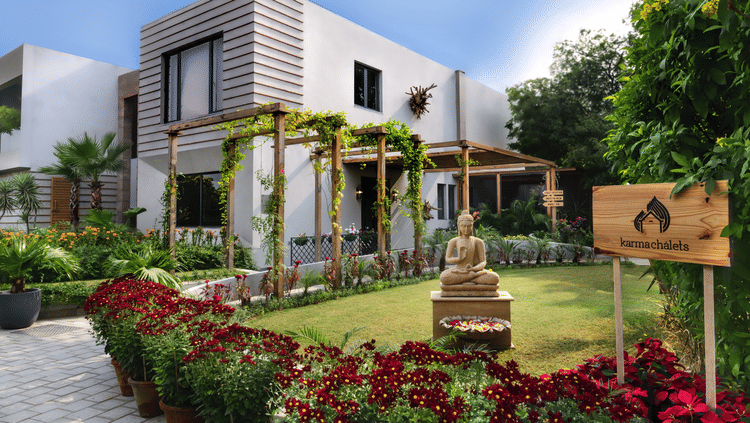 exterior facade of one of the villas with a garden in front of it - Karma Lakelands.