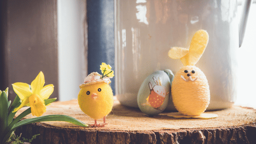easter eggs decorated as bunnies set up on a table