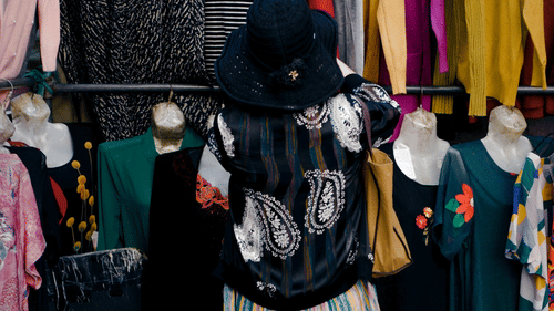 a woman shopping for clothes at a shop
