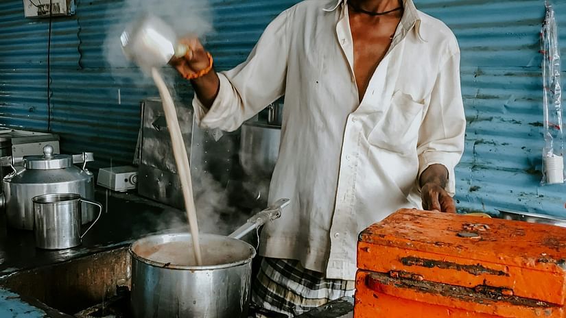 A man pouring liquid into a huge vessel