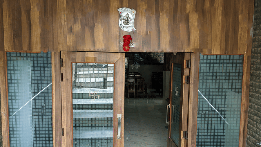 An entrance with wooden paneling and glass windows - Hotel Goverdhan, Agra