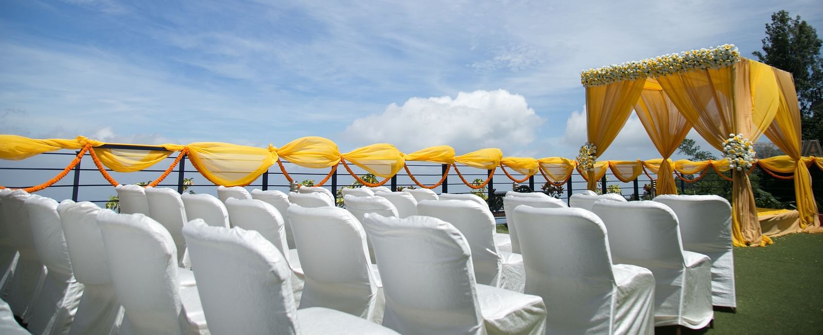 An image of the open banquet space with chairs and decoration - Great Trails Yercaud by GRT Hotels