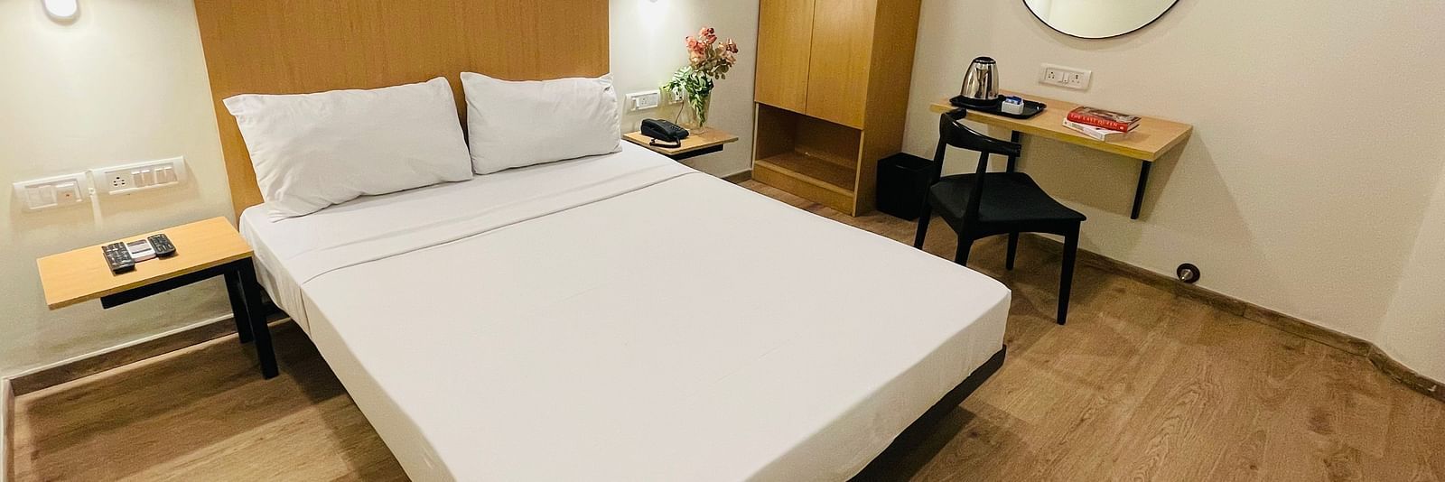 A double bed and a work desk at Sanctum Suites Richmond Road, Bangalore