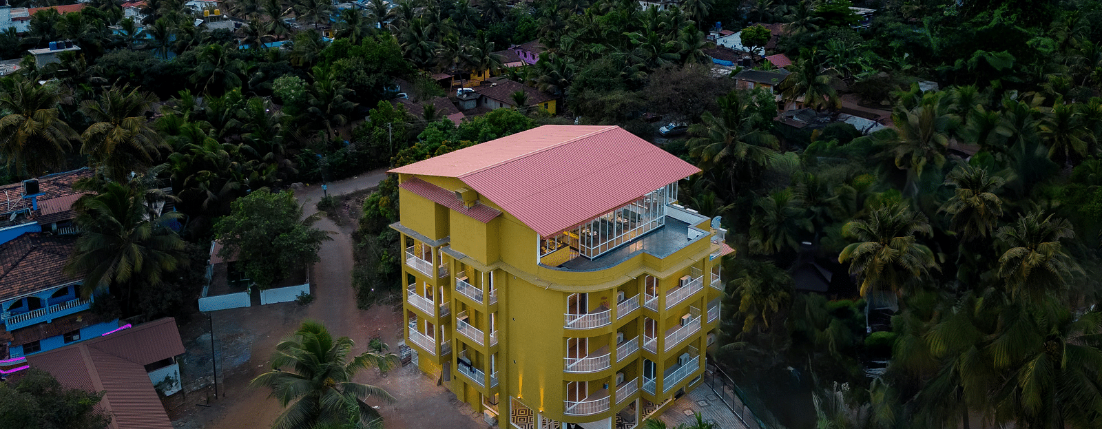 An aerial view image of a facade surrounded by trees - Bedzzz Xclusiv Morjim, Goa